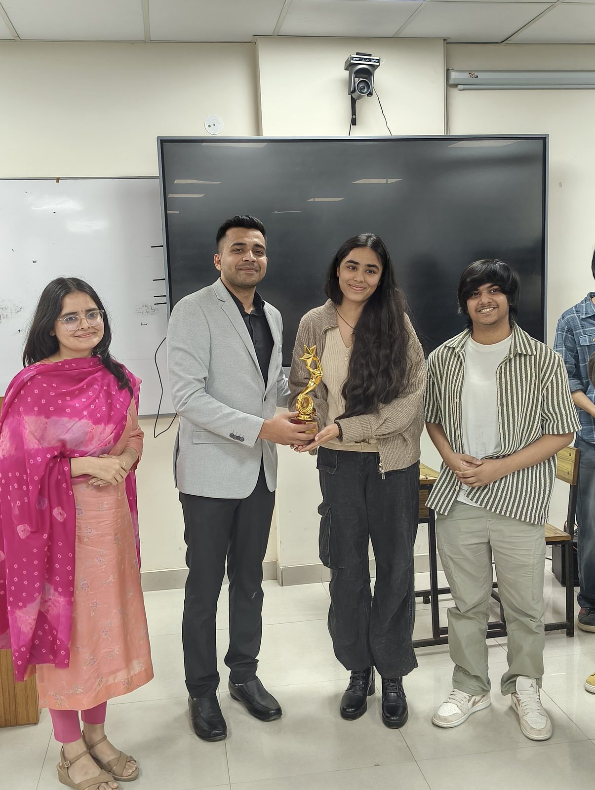 Abhishek presenting an award to students